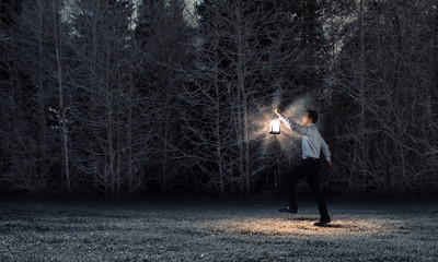 Businessman in search in darkness