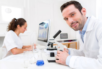 Scientist and her assistant in a laboratory