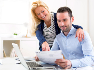 Attractive couple doing administrative paperwork