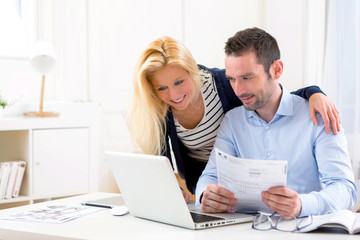 Attractive couple doing administrative paperwork