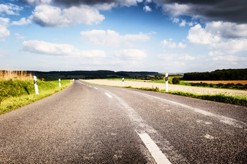 Summer road with cloudy sky