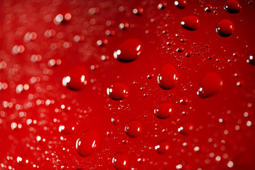 Water drops on color surface background, macro view