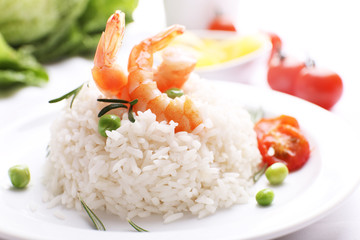 Boiled rice with shrimps served on table, close-up