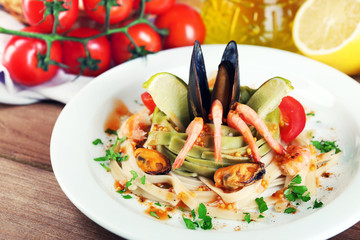 Tasty pasta with shrimps, mussels, tomatoes