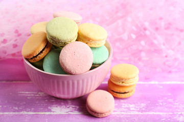 Assortment of gentle colorful macaroons in colorful mug