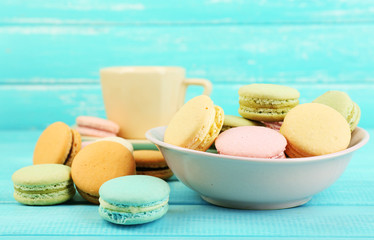 Assortment of gentle colorful macaroons in colorful bowl and