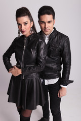 fashion couple posing on grey studio background