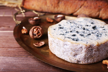 Blue cheese with nuts, baguette and hay