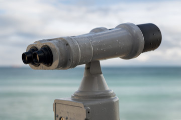 sea binoculars by the Black Sea shore. working with coins.