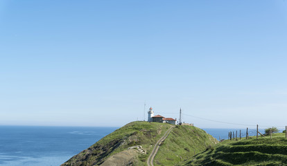 Fototapeta na wymiar lighthouse by the black ses coast