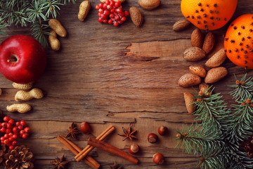 Fruits with nuts, spices and sprigs of Christmas tree