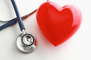 An image of a stethoscope and a red heart isolated on white