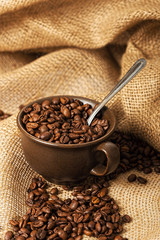Coffee beans in a cup with spoon