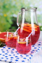 Pink lemonade in glasses and pitcher