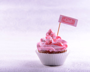 Delicious cupcake with inscription on table on beige background