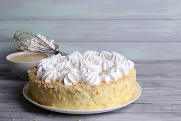 Tasty homemade meringue cake on wooden table