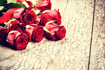 Bouquet of red roses on grunge background