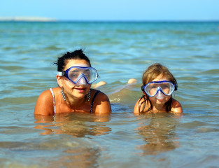 Vacation - snorkeling daughter with mother