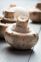 White button mushrooms on a wooden blue table
