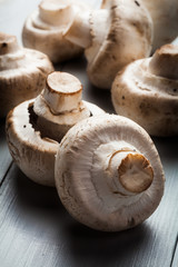White button mushrooms on a wooden blue table