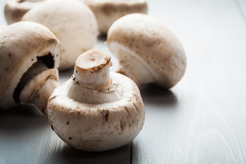 White button mushrooms on a wooden blue table