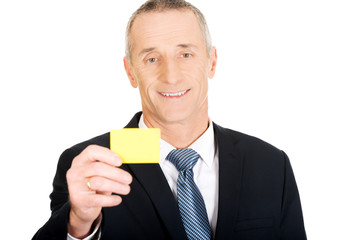 Businessman showing a yellow identity name card