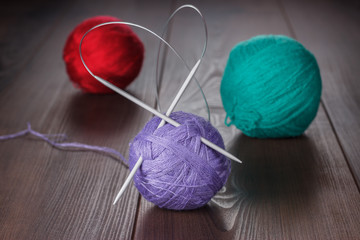 knitting needles and balls of threads
