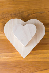 wood box shaped heart on brown wooden background