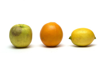 Apple, lemon and orange on a white background. Photo.