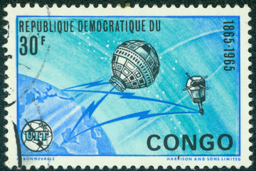 stamp  shows image of the Earth and satellites