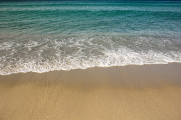 Lonely untouched beachside with foam