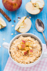 Tasty oatmeal with apples and cinnamon