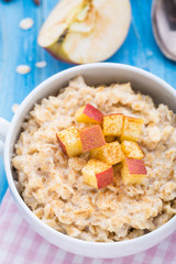 Tasty oatmeal with apples and cinnamon