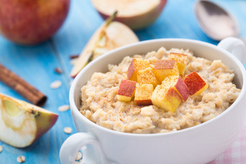 Tasty oatmeal with apples and cinnamon