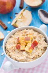 Tasty oatmeal with apples and cinnamon