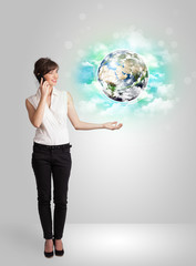Young woman with earth and cloud concept