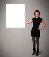 Young woman presenting white paper copy space