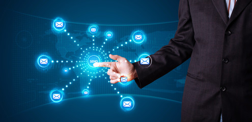 Businessman pressing virtual messaging type of icons