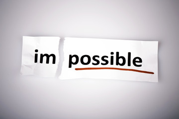 The word impossible changed to possible on torn paper