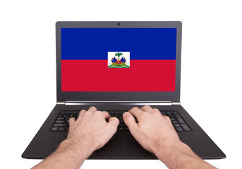 Hands working on laptop, Haiti