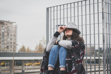 Fototapeta premium Beautiful young brunette posing in the city streets
