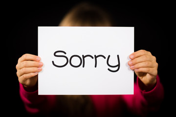 Child holding Sorry sign