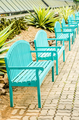A line of green bench in the park