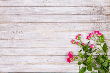Fototapeta premium Red roses on wooden backround. Copy space