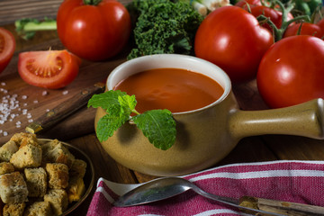 Tomato soup on rustic kitchen table