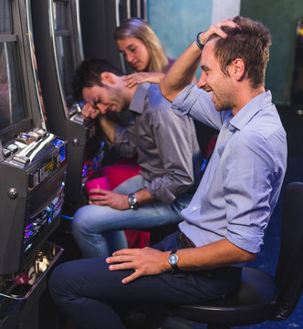 Group of Friend Playing with Slot Machines