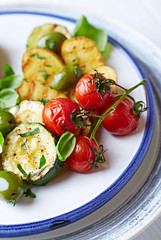 Soft grilled zucchini, potatoes and cherry tomatoes with olives