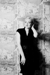 blond woman posing on wall background black and white