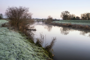 Landscape Winter surnise of river and frosty fields