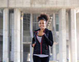 Happy young woman running exercise